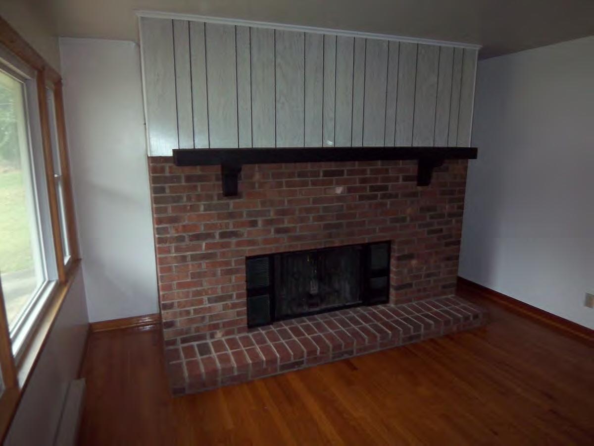 2610 The Great Road Fieldale, VA 24089 - Photo 3 of 9 a living room with a fireplace furniture and a wooden floor