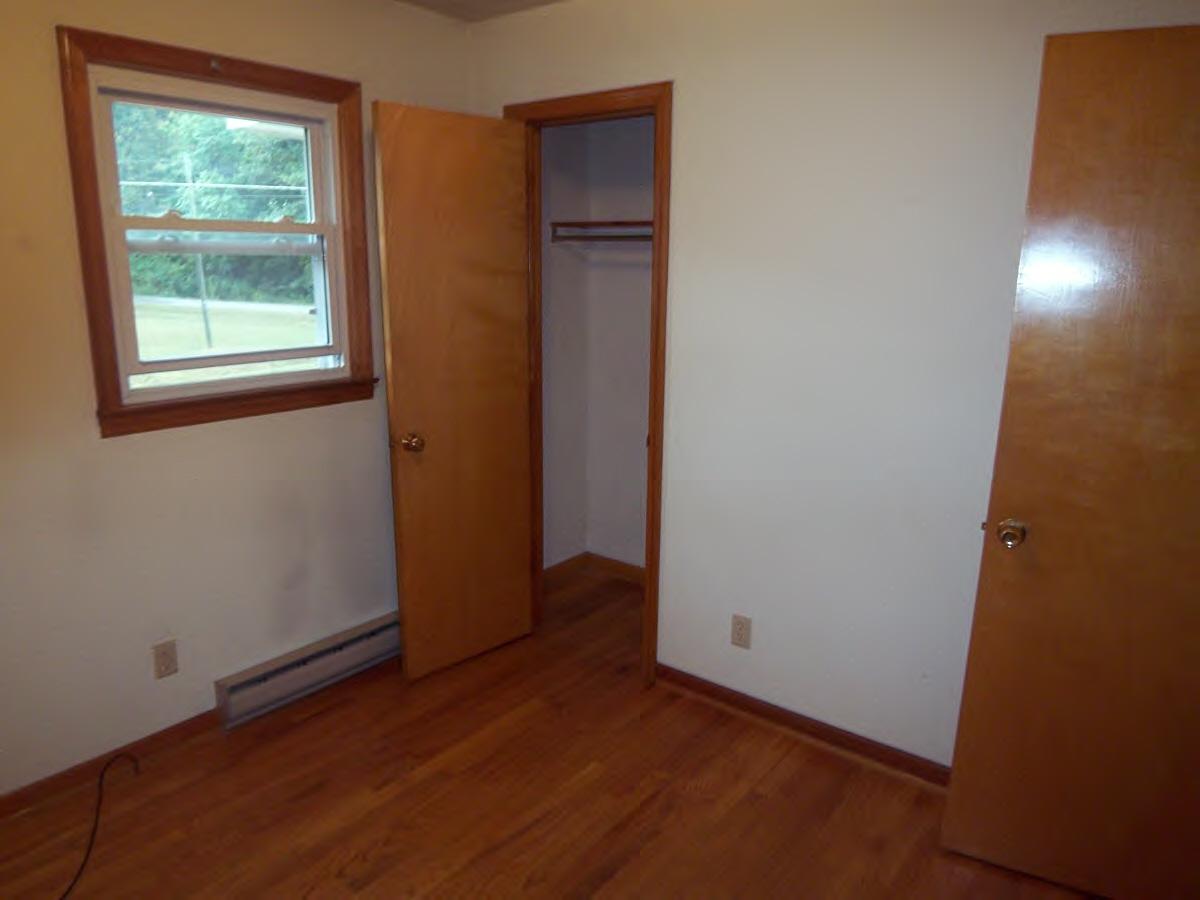2610 The Great Road Fieldale, VA 24089 - Photo 6 of 9 an empty room with wooden floor and windows