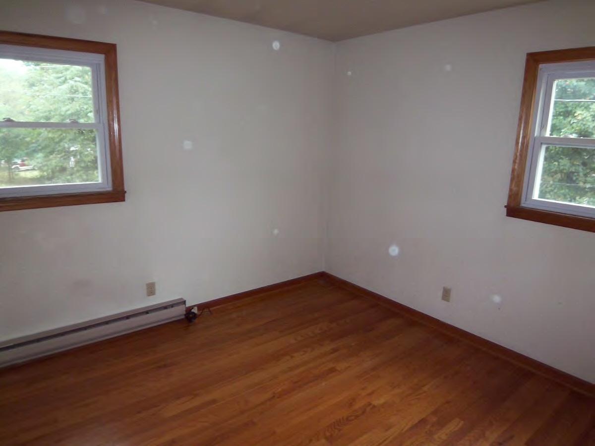 2610 The Great Road Fieldale, VA 24089 - Photo 7 of 9 an empty room with wooden floor and windows