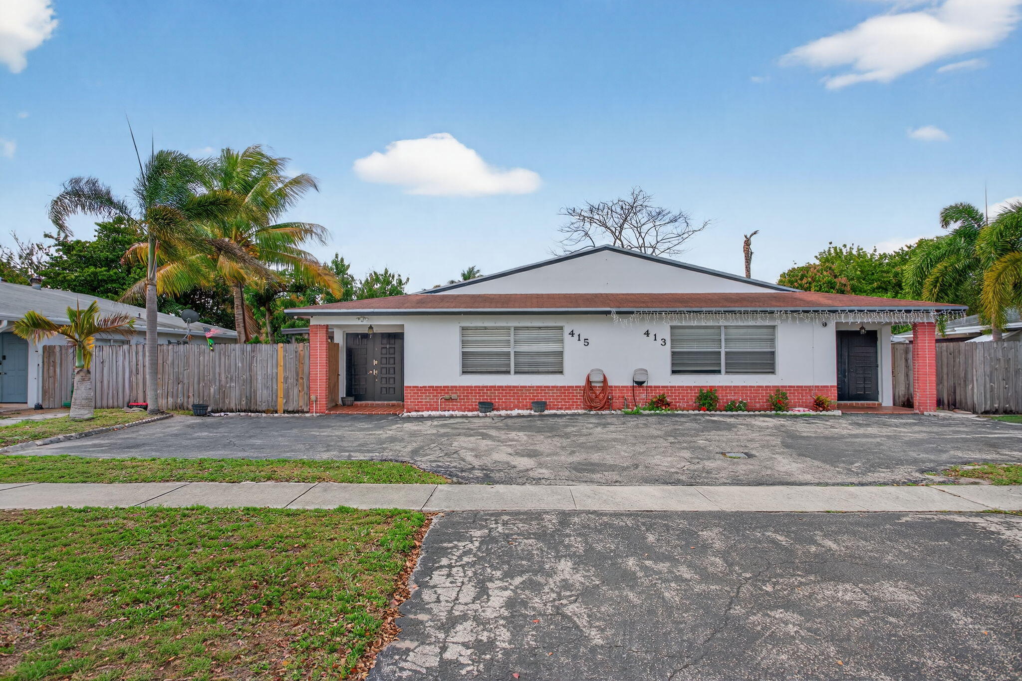 415 Southwest 61st Terrace Margate, FL 33068 - Photo 1 of 39 a front view of a house with a yard and garage