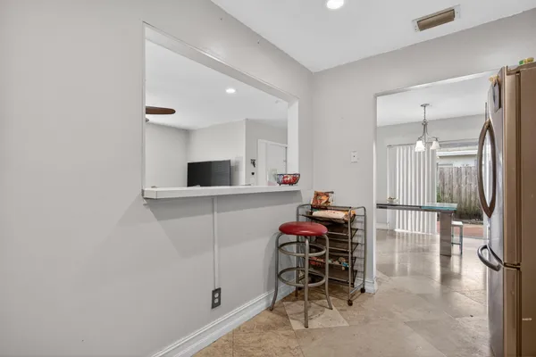 a hallway with a table and chairs
