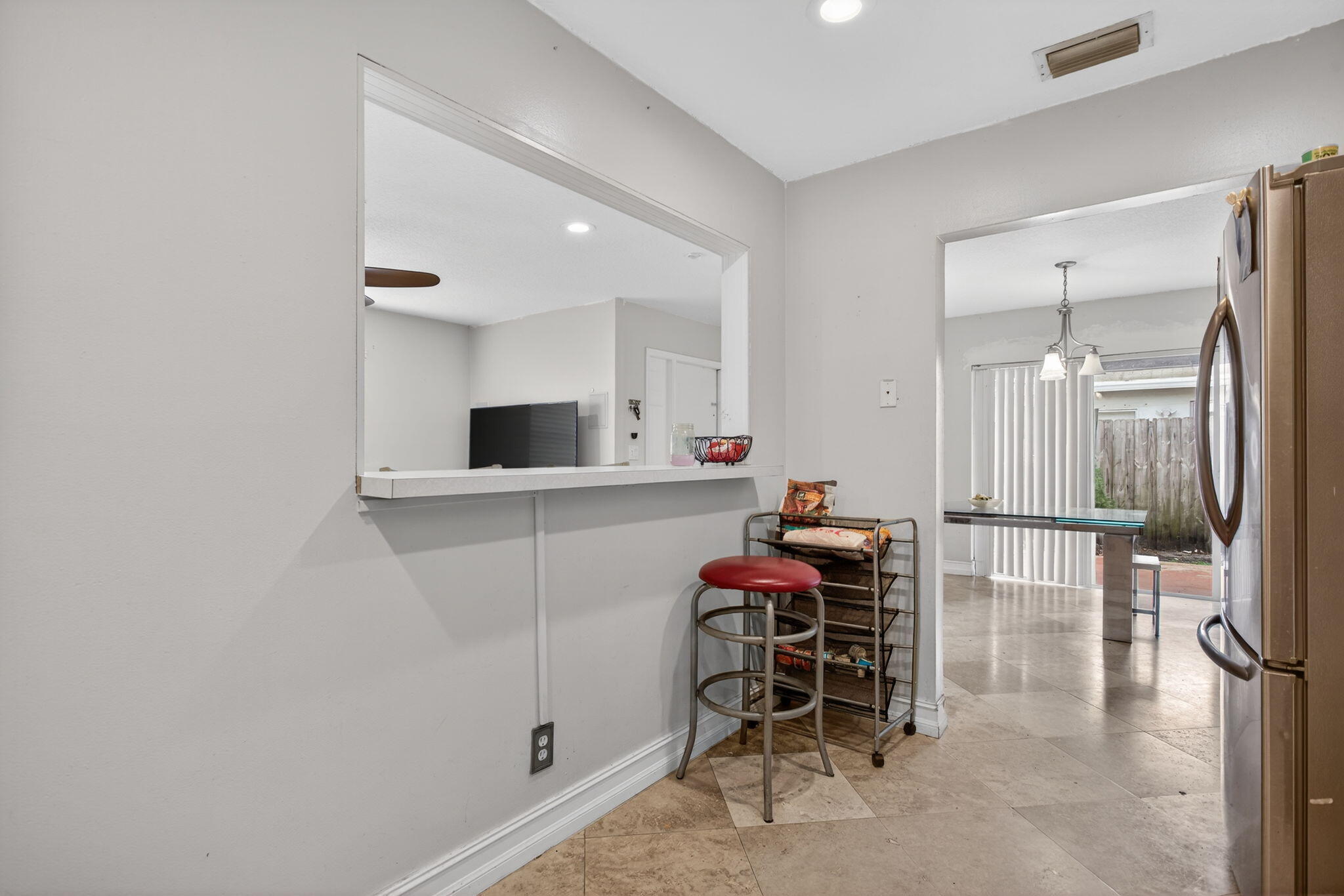 415 Southwest 61st Terrace Margate, FL 33068 - Photo 12 of 39 a hallway with a table and chairs