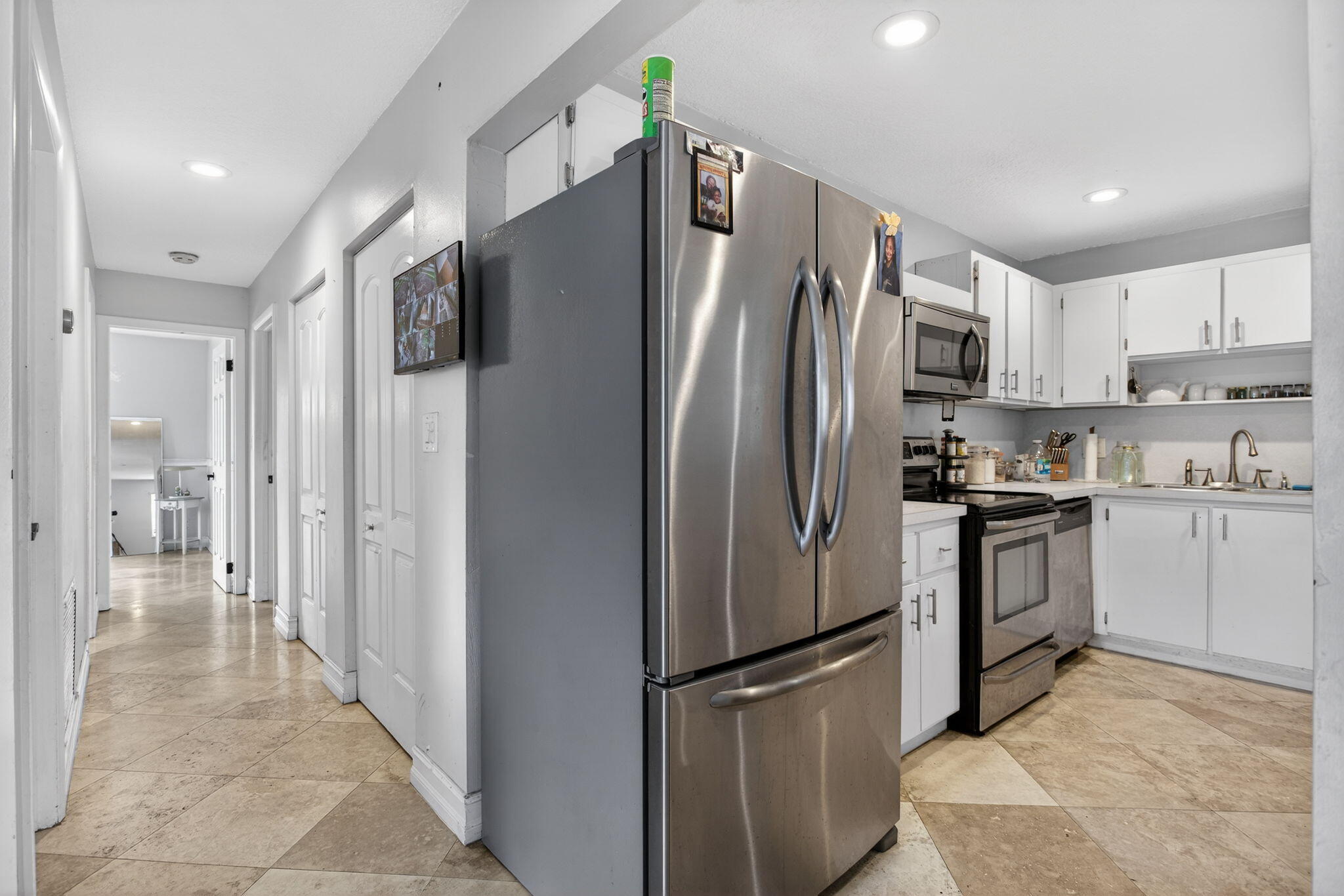 415 Southwest 61st Terrace Margate, FL 33068 - Photo 13 of 39 a kitchen with stainless steel appliances a refrigerator sink and cabinets