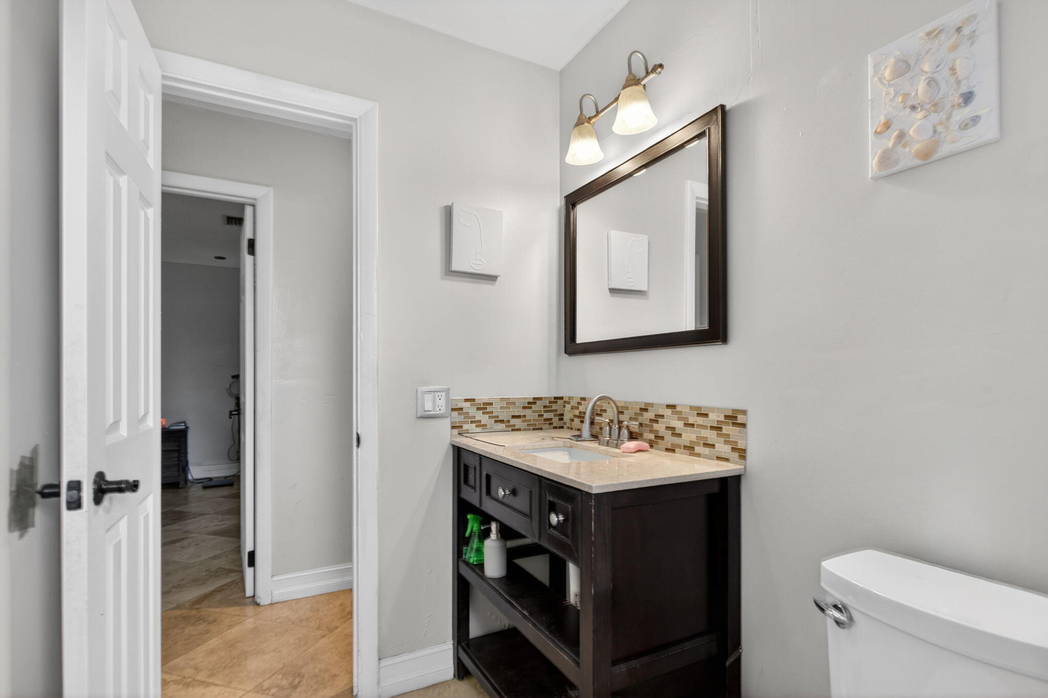 415 Southwest 61st Terrace Margate, FL 33068 - Photo 17 of 39 a bathroom with a sink toilet and mirror