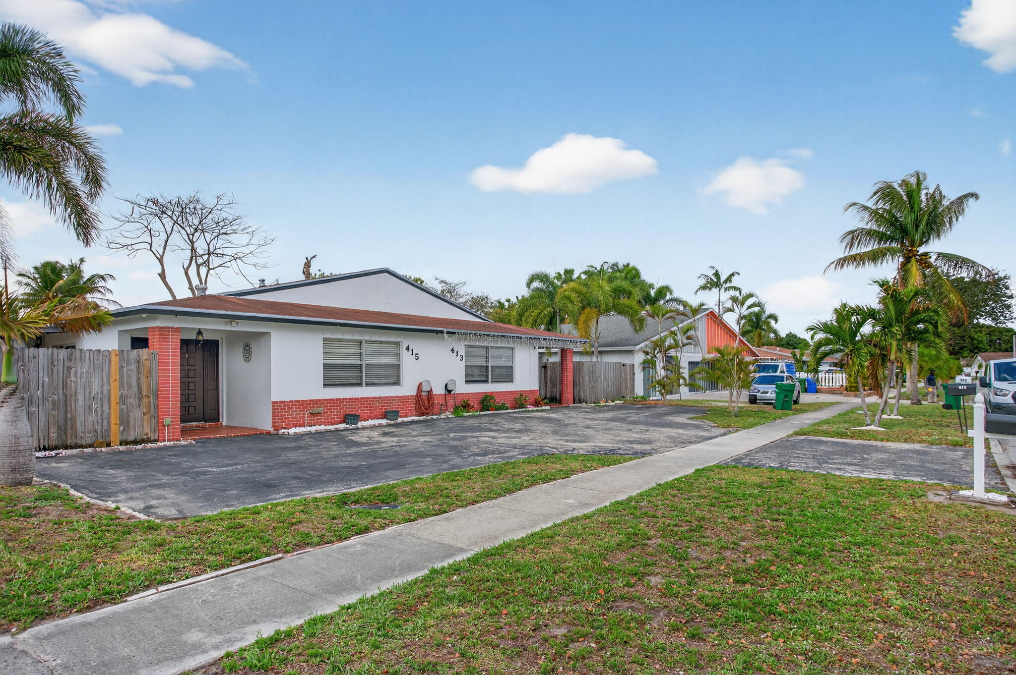 415 Southwest 61st Terrace Margate, FL 33068 - Photo 2 of 39 a front view of a house with a yard and potted plants