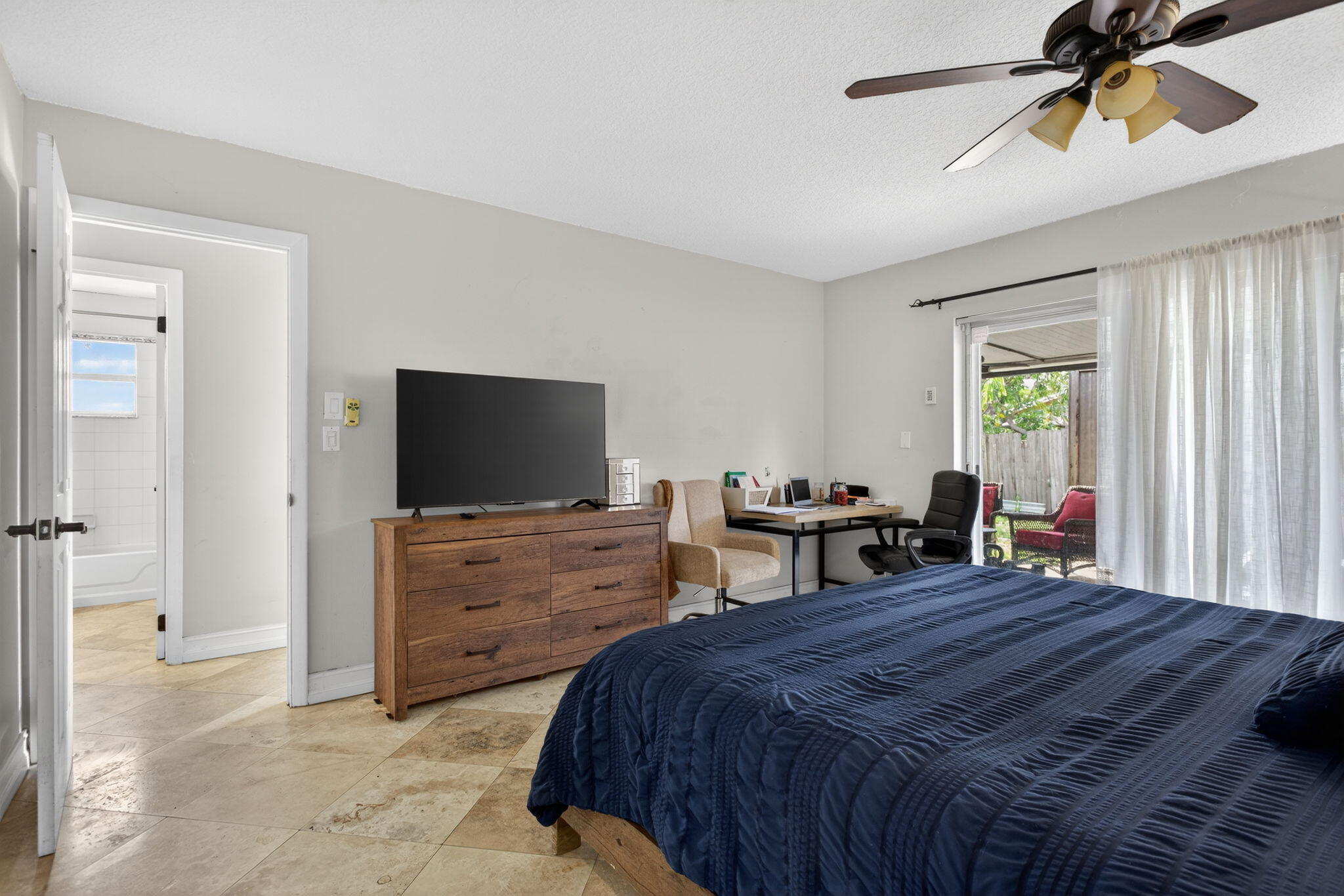 415 Southwest 61st Terrace Margate, FL 33068 - Photo 25 of 39 a bedroom with a bed and a chandelier