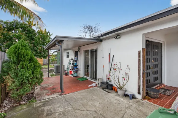 a view of a chair and table in backyard of the house