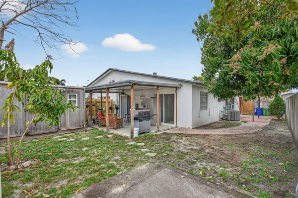 a patio with glass top table and chairs