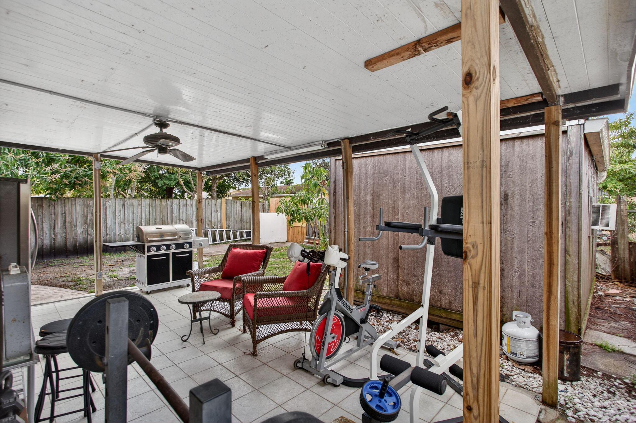 415 Southwest 61st Terrace Margate, FL 33068 - Photo 30 of 39 a patio with glass top table and chairs