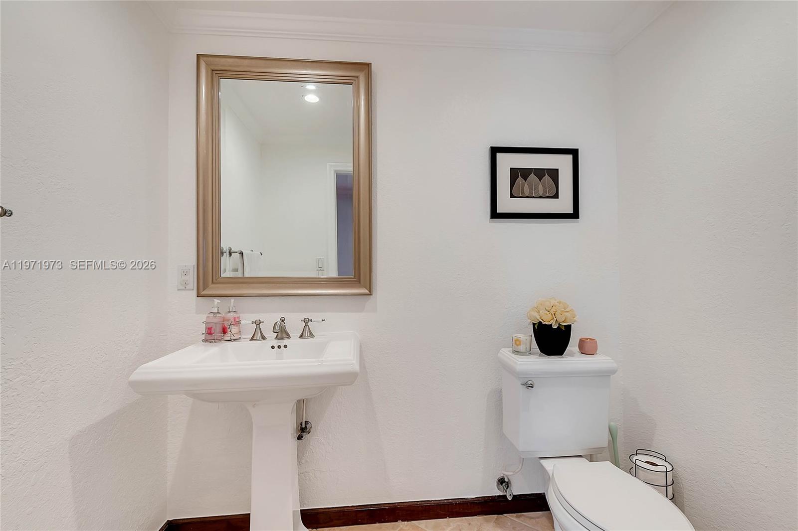 35 Southwest 20th Road Miami, FL 33129 - Photo 11 of 50 a bathroom with a sink mirror and toilet