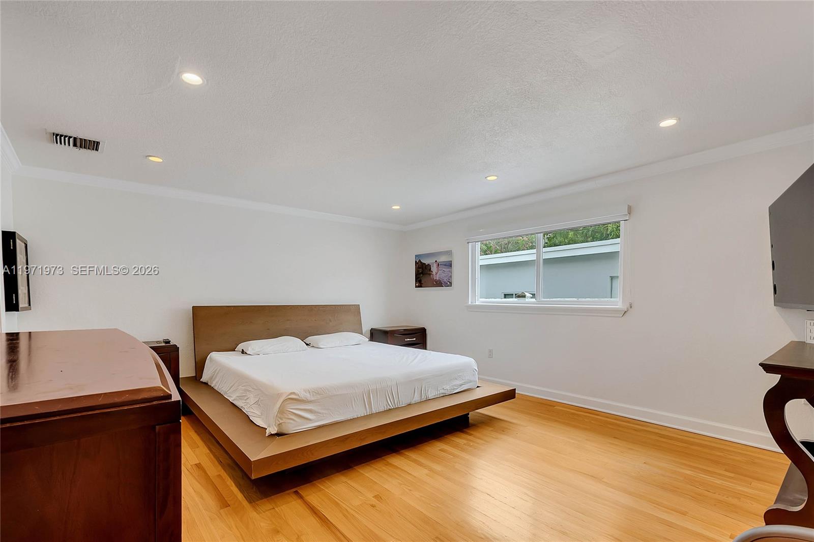 35 Southwest 20th Road Miami, FL 33129 - Photo 12 of 50 a bedroom with a bed and a table in it