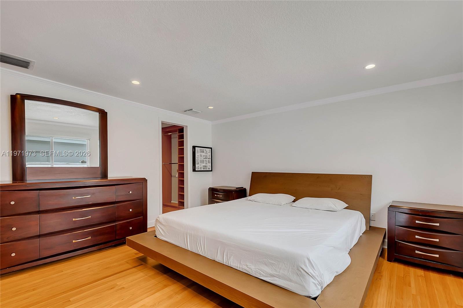 35 Southwest 20th Road Miami, FL 33129 - Photo 13 of 50 a bedroom with a bed and wooden floor