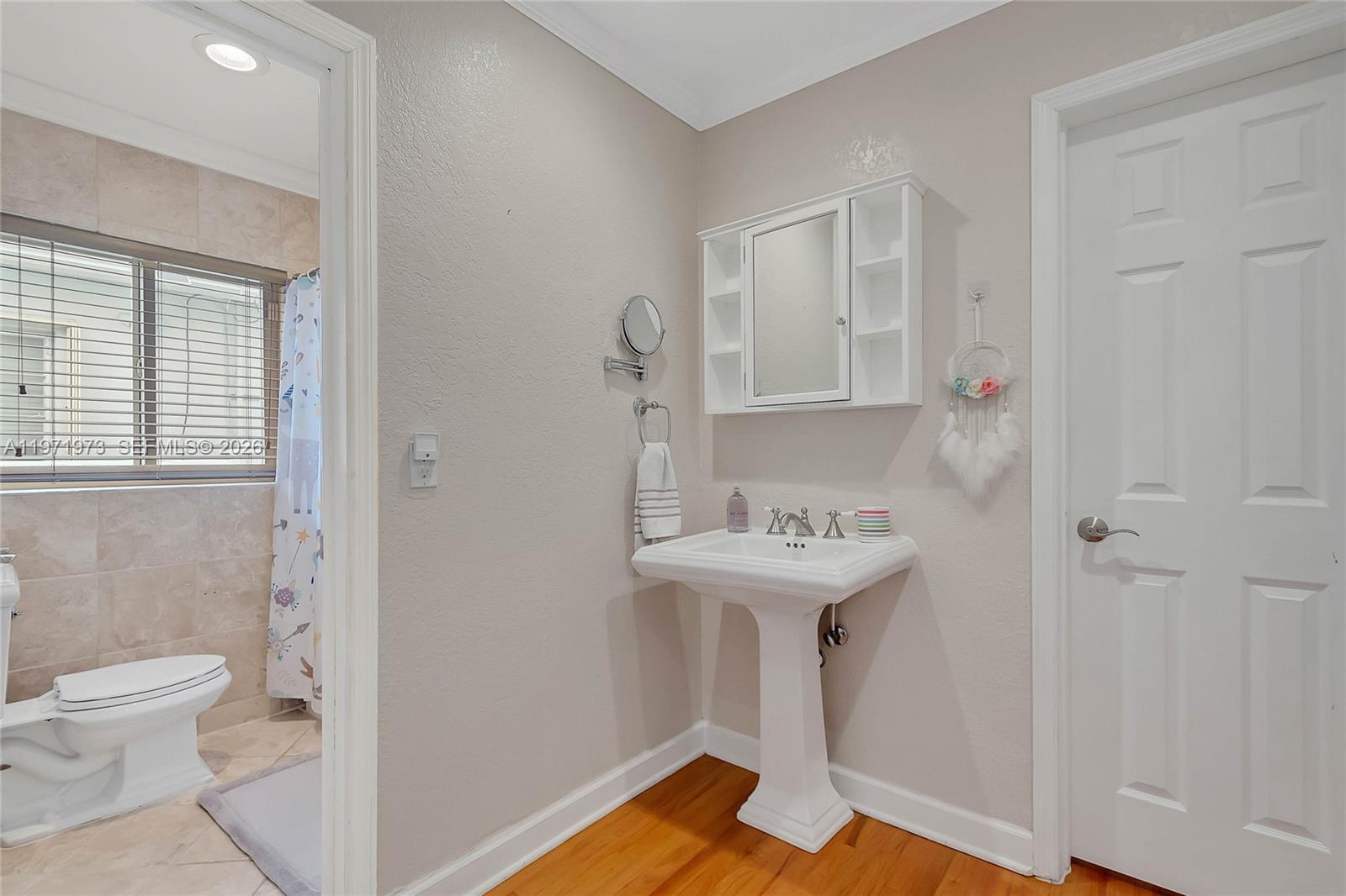 35 Southwest 20th Road Miami, FL 33129 - Photo 17 of 50 a bathroom with a sink a toilet and a mirror