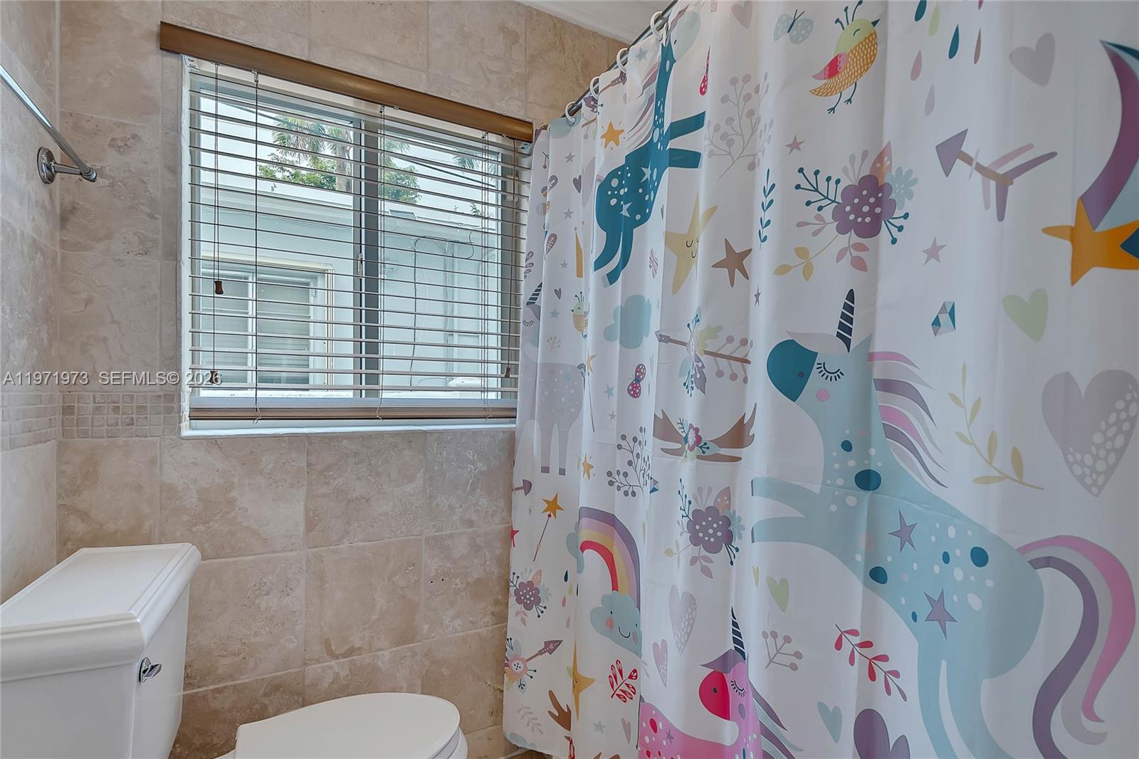 35 Southwest 20th Road Miami, FL 33129 - Photo 18 of 50 a bathroom with a bathtub and a shower curtain