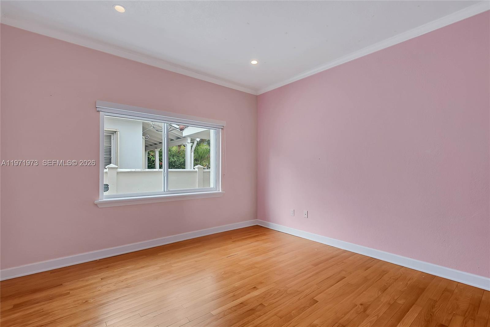 35 Southwest 20th Road Miami, FL 33129 - Photo 20 of 50 a view of an empty room with wooden floor and a window