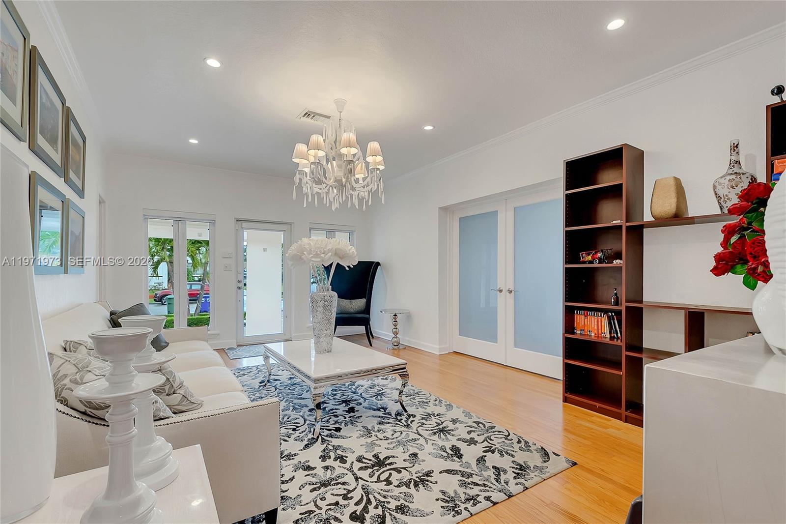 35 Southwest 20th Road Miami, FL 33129 - Photo 4 of 50 a living room with furniture and a chandelier