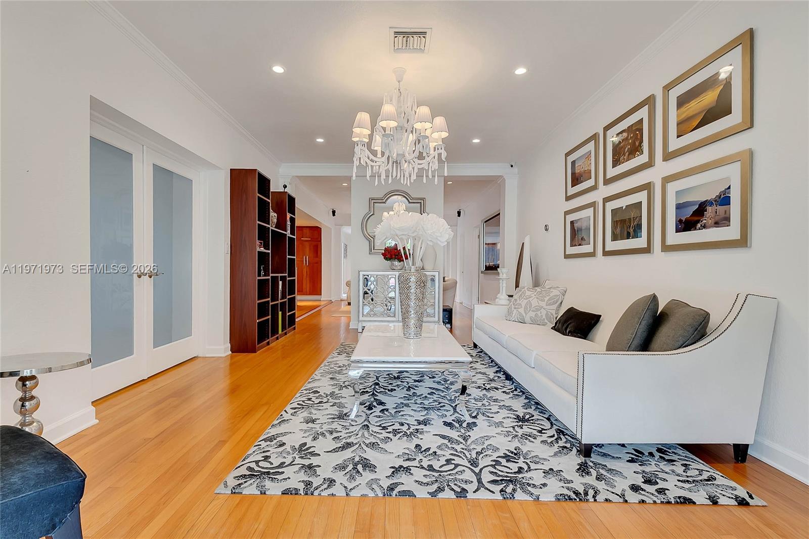 35 Southwest 20th Road Miami, FL 33129 - Photo 6 of 50 a large white kitchen with a stove a faucet a chandelier