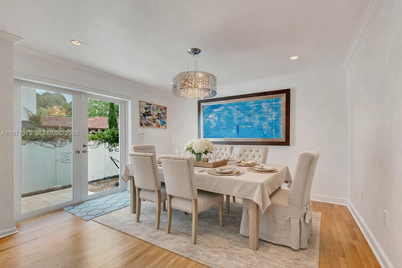 35 Southwest 20th Road Miami, FL 33129 - Photo 10 of 50 a dining room with furniture a chandelier and wooden floor