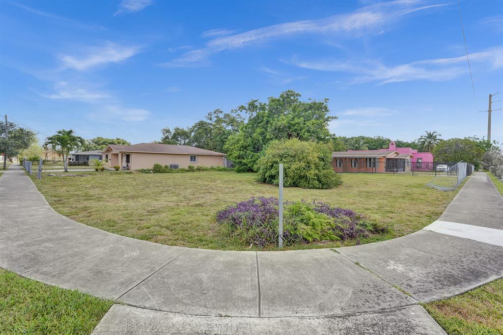 1895 Northwest 58th Street Miami, FL 33142 - Photo 12 of 14 a view of a garden with a building in the background