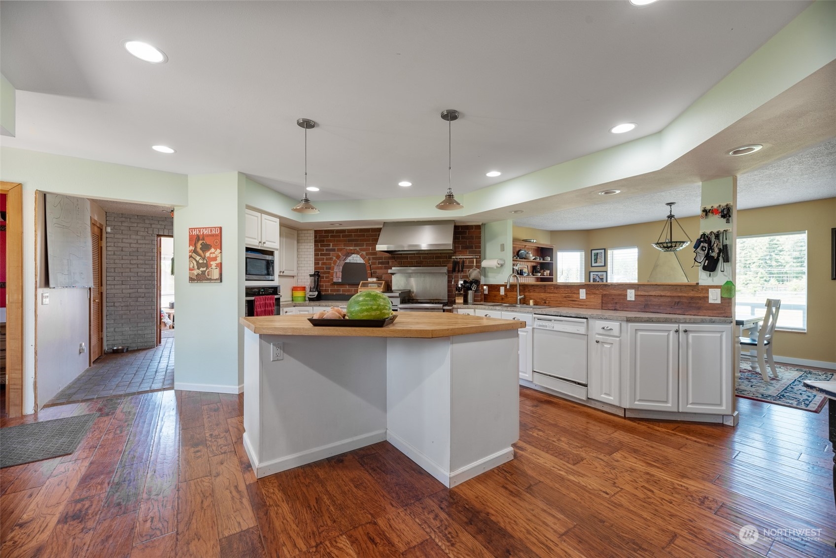 876 Logan Hill Road Chehalis, WA 98532 - Photo 7 of 40 a kitchen with stainless steel appliances granite countertop a lot of counter space and wooden floors