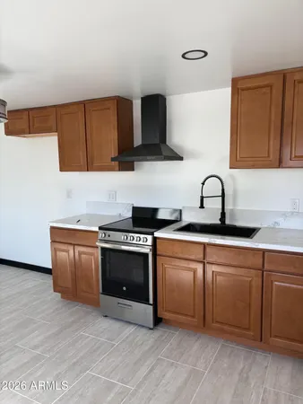 a kitchen with stainless steel appliances granite countertop a sink and a stove top oven