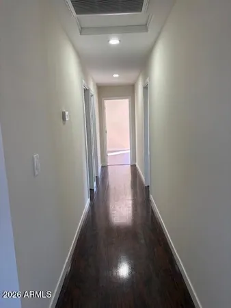a view of hallway with wooden floor
