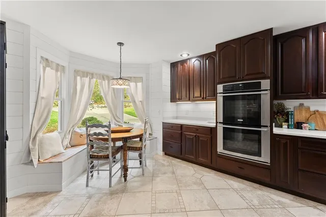 a kitchen with granite countertop wooden cabinets and stainless steel appliances