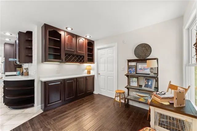 a living room with furniture a flat screen tv and a wooden floor