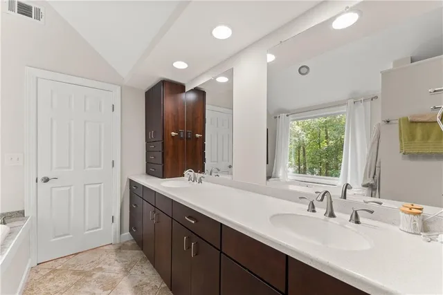 a bathroom with a double vanity sink and a mirror