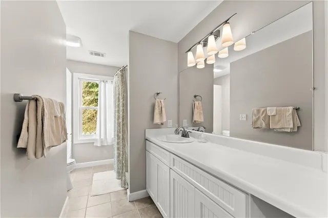 a bathroom with a sink a mirror and a shower