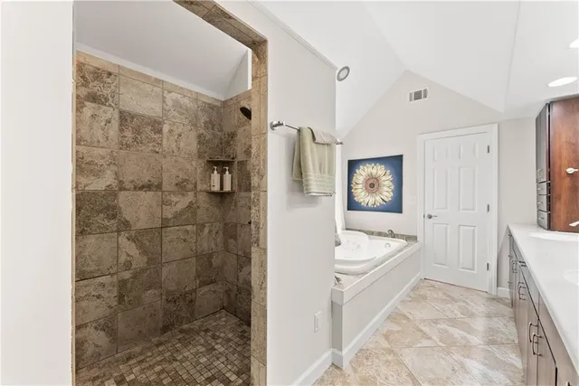 a bathroom with a bathtub sink and mirror