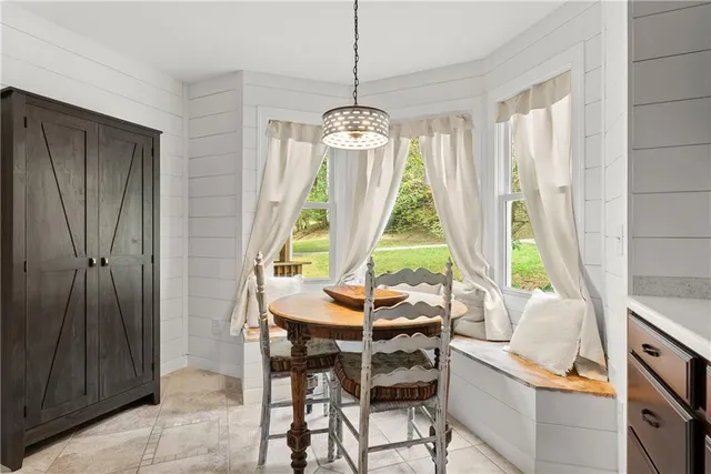 a dining room with furniture a chandelier and wooden floor