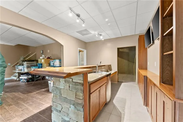a spacious bathroom with a tub a mirror and a shower