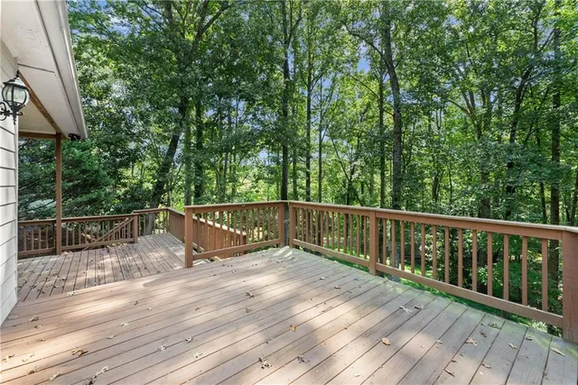 a view of balcony with wooden floor and fence