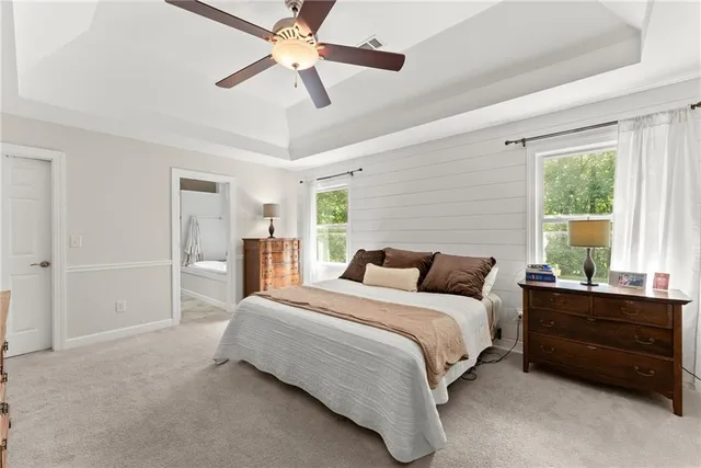 a bedroom with a bed dresser and a window