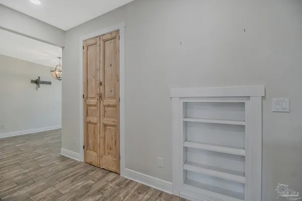 a view of a hallway with wooden floor