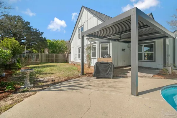a view of a house with backyard and a house