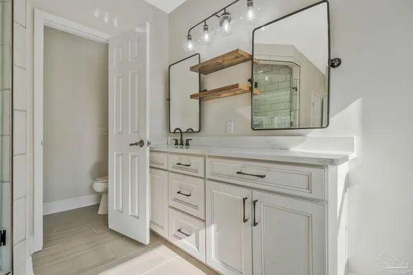 a bathroom with a shower and a sink