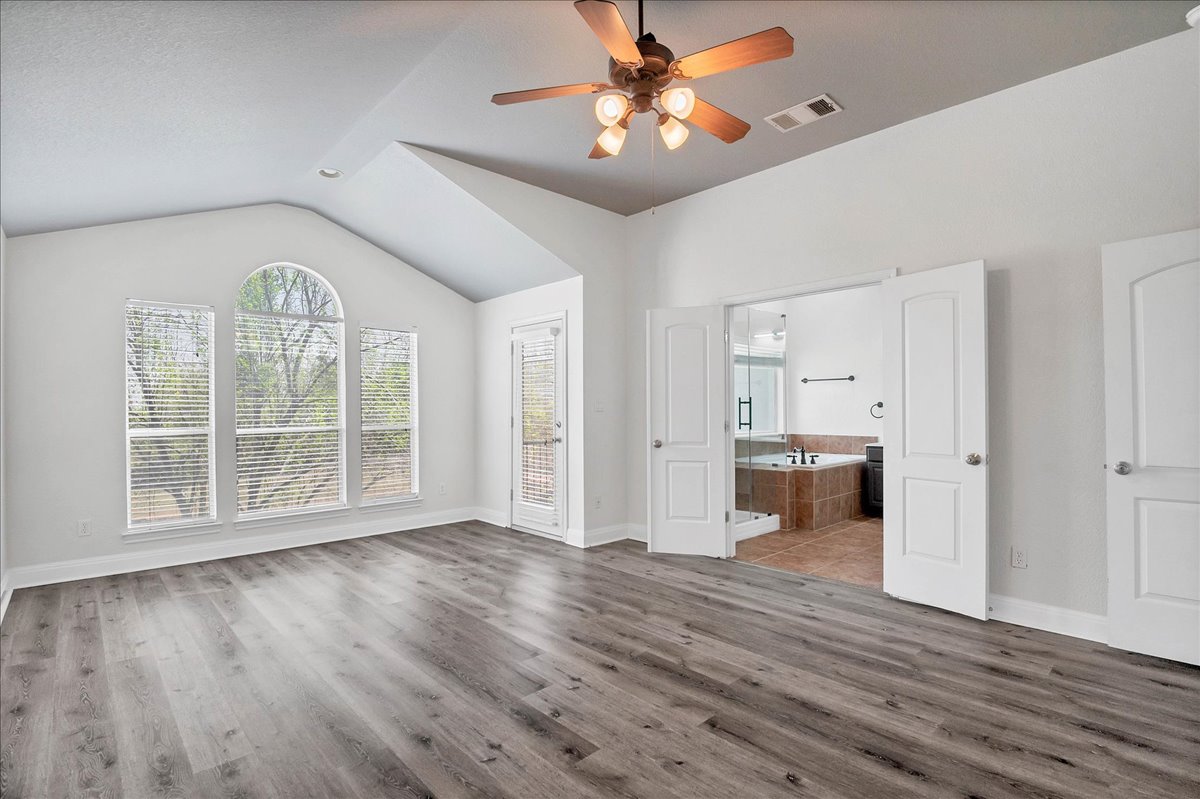 114 Aria Ridge, Unit 802 Lakeway, TX 78738 - Photo 11 of 30 a view of empty room with wooden floor and fan