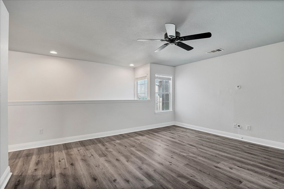 114 Aria Ridge, Unit 802 Lakeway, TX 78738 - Photo 16 of 30 wooden floor in an empty room with a window