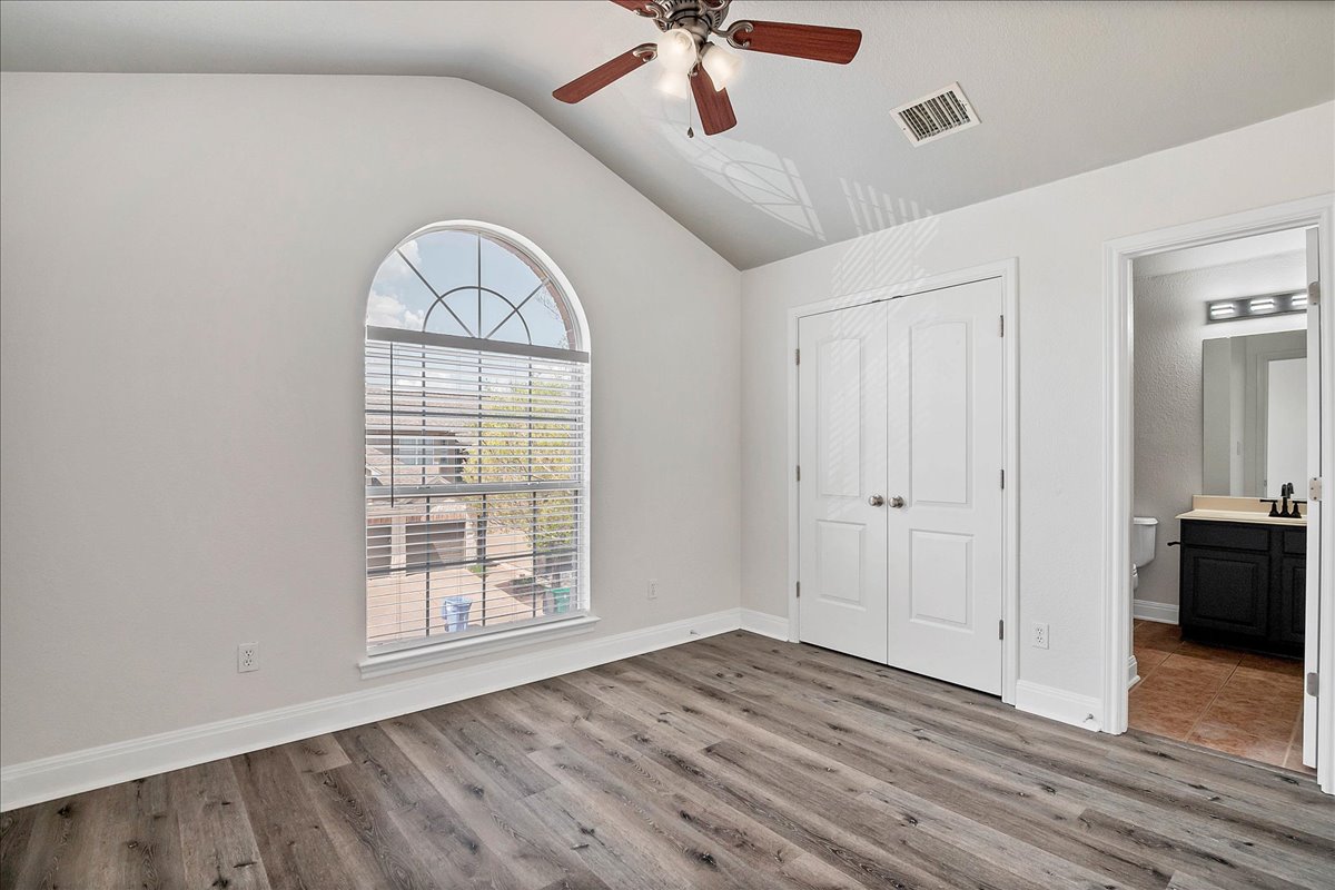 114 Aria Ridge, Unit 802 Lakeway, TX 78738 - Photo 20 of 30 a view of an empty room with a window and wooden floor
