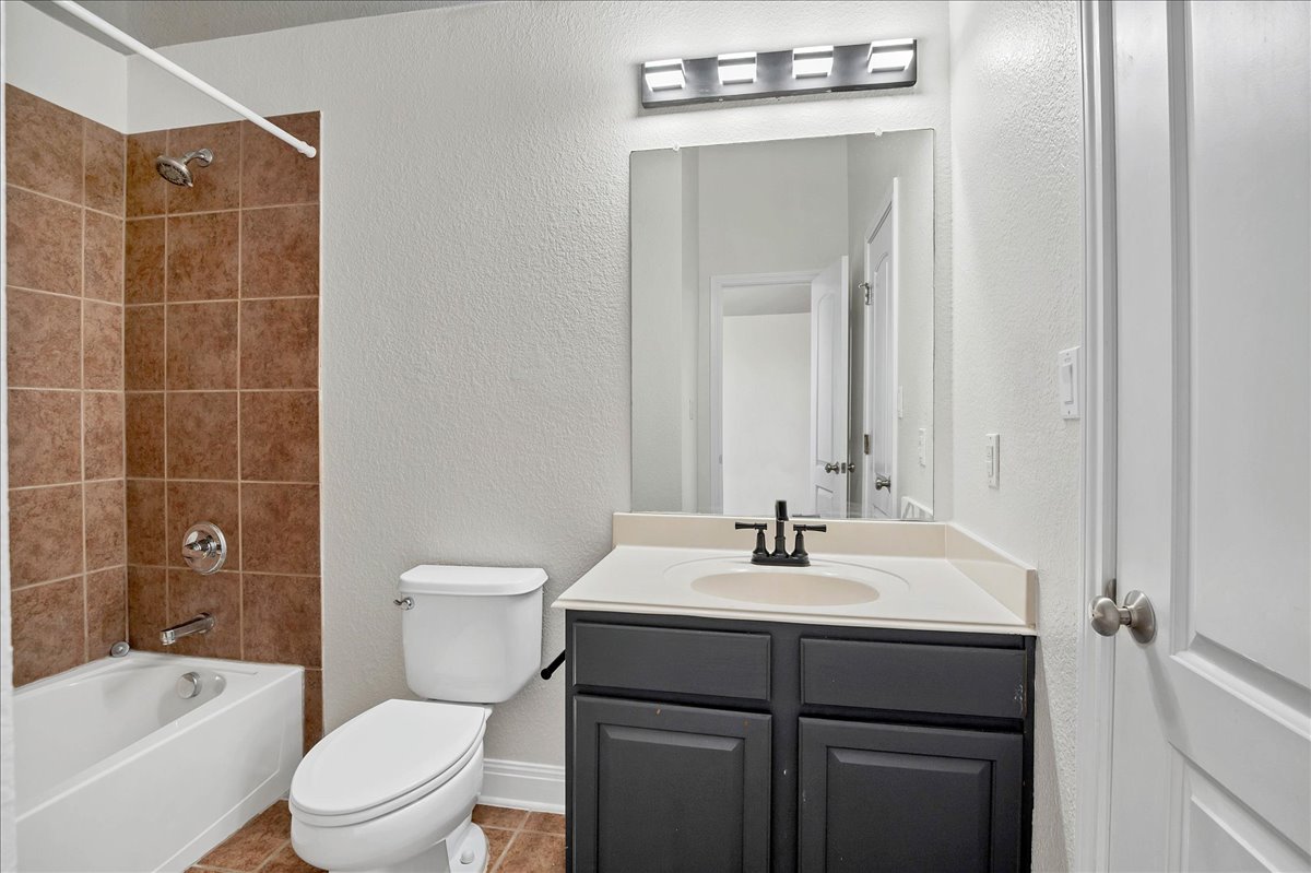 114 Aria Ridge, Unit 802 Lakeway, TX 78738 - Photo 21 of 30 a bathroom with a sink a toilet and shower