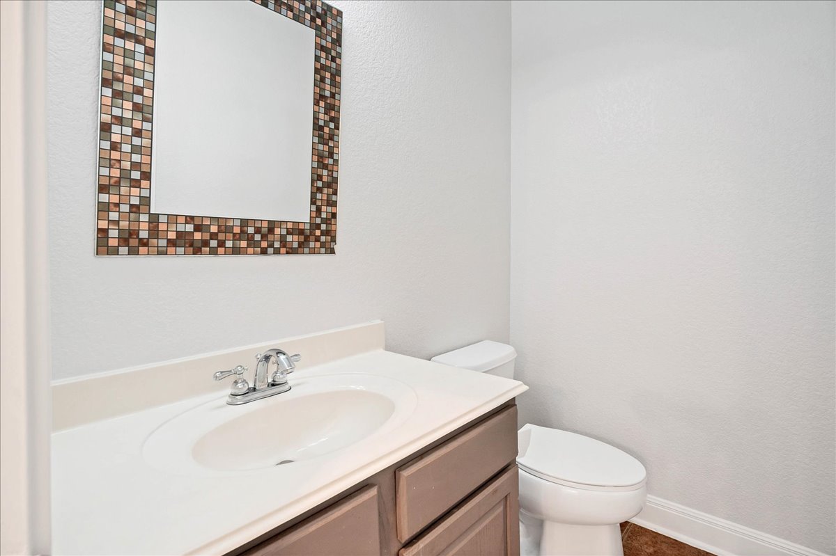 114 Aria Ridge, Unit 802 Lakeway, TX 78738 - Photo 25 of 30 a bathroom with a sink mirror and toilet