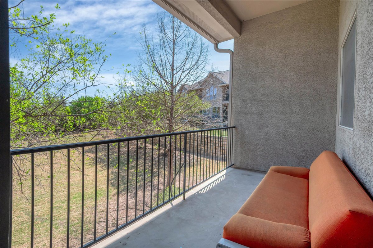 114 Aria Ridge, Unit 802 Lakeway, TX 78738 - Photo 26 of 30 a balcony with wooden floor