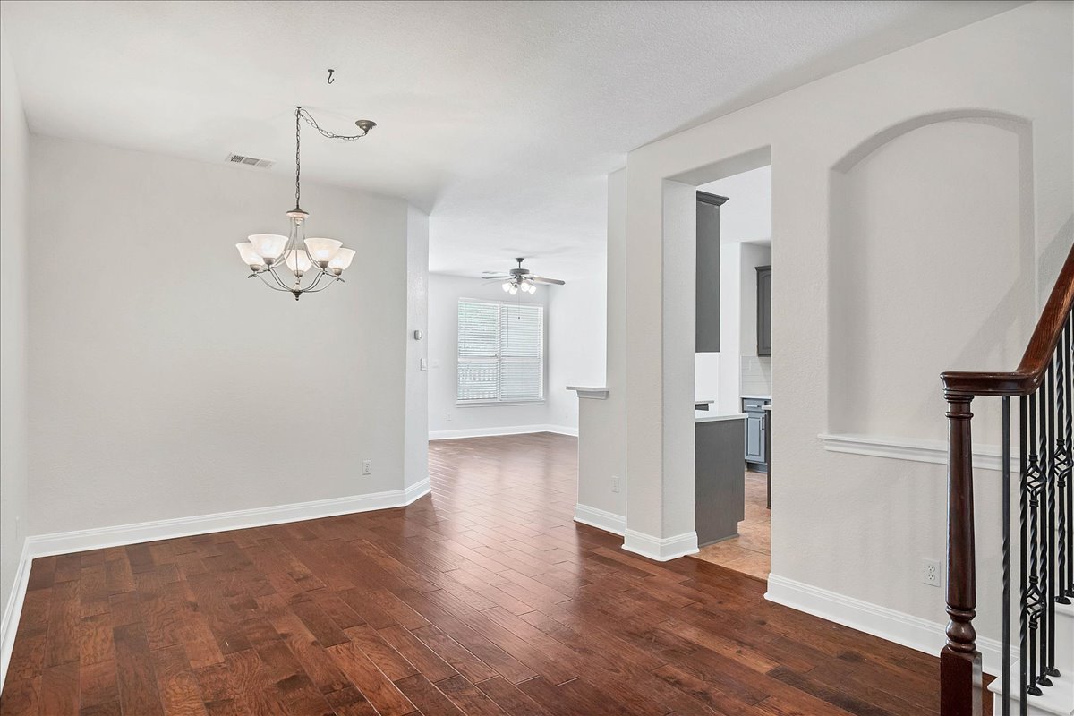 114 Aria Ridge, Unit 802 Lakeway, TX 78738 - Photo 5 of 30 a view of a room with wooden floor and stairs