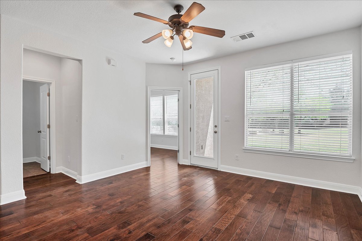 114 Aria Ridge, Unit 802 Lakeway, TX 78738 - Photo 6 of 30 a view of an empty room with window and wooden floor