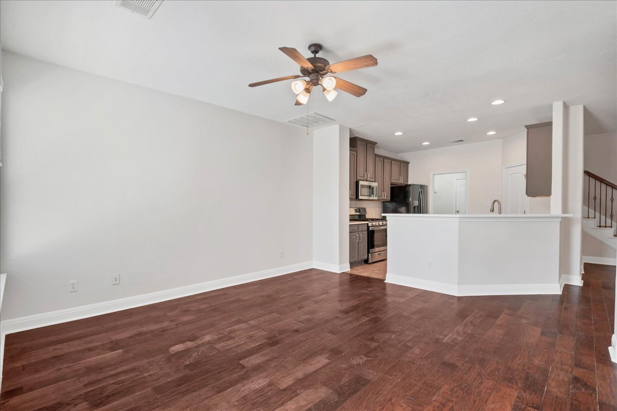 114 Aria Ridge, Unit 802 Lakeway, TX 78738 - Photo 7 of 30 a view of a kitchen with a sink a refrigerator and a ceiling fan