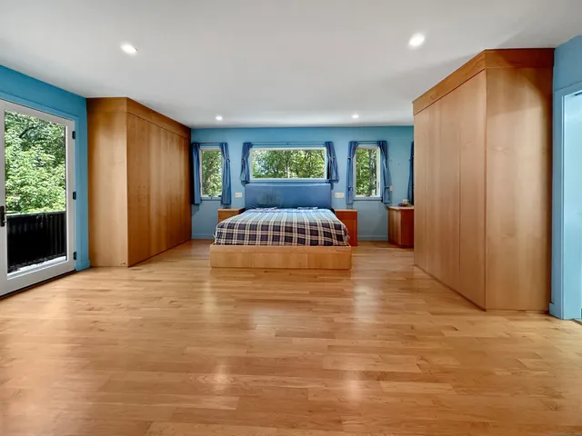 a spacious bedroom with a large bed and a large window