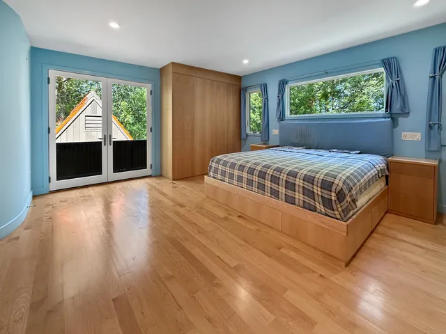 a bedroom with a large bed and a dresser