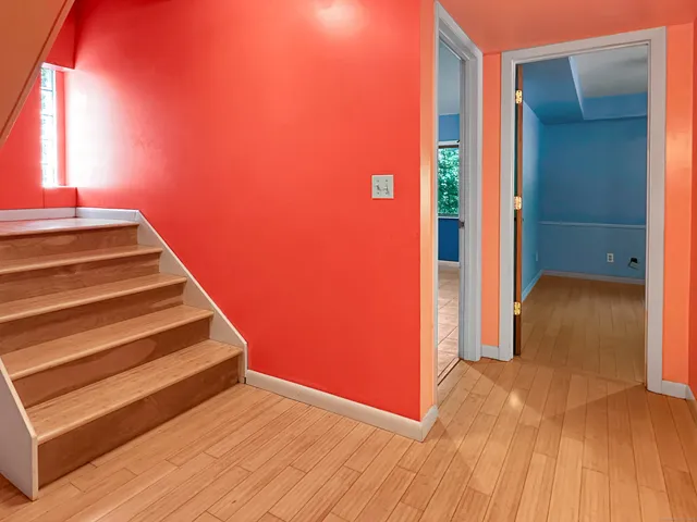 a view of a room with wooden floor and a window